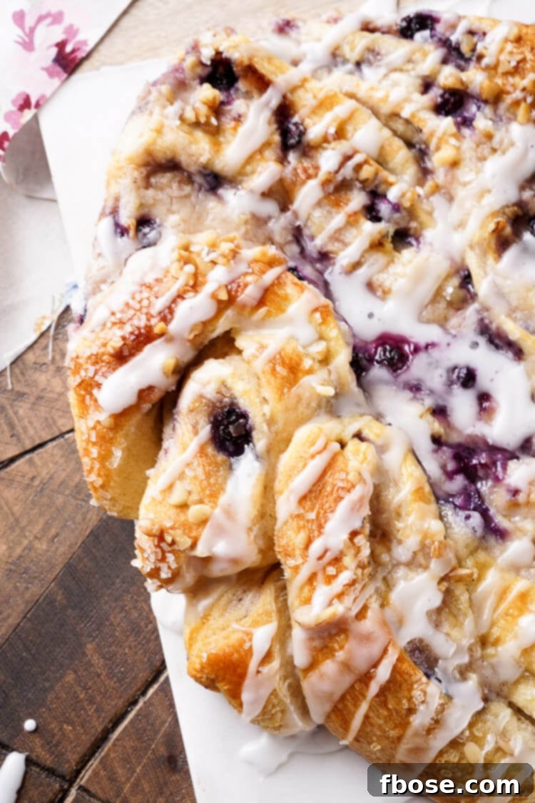 Spiced Blueberry Cream Cheese Twirl 5 This Blueberry Spice Cream Cheese Breakfast Ring is the perfect addition to a holiday brunch. A simple and sweet filling is wrapped up in crescent dough and topped with chopped pecans and icing for a delicious morning pastry the whole family can enjoy!