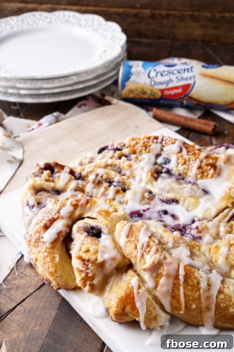 Spiced Blueberry Cream Cheese Twirl 6 This Blueberry Spice Cream Cheese Breakfast Ring is the perfect addition to a holiday brunch. A simple and sweet filling is wrapped up in crescent dough and topped with chopped pecans and icing for a delicious morning pastry the whole family can enjoy!