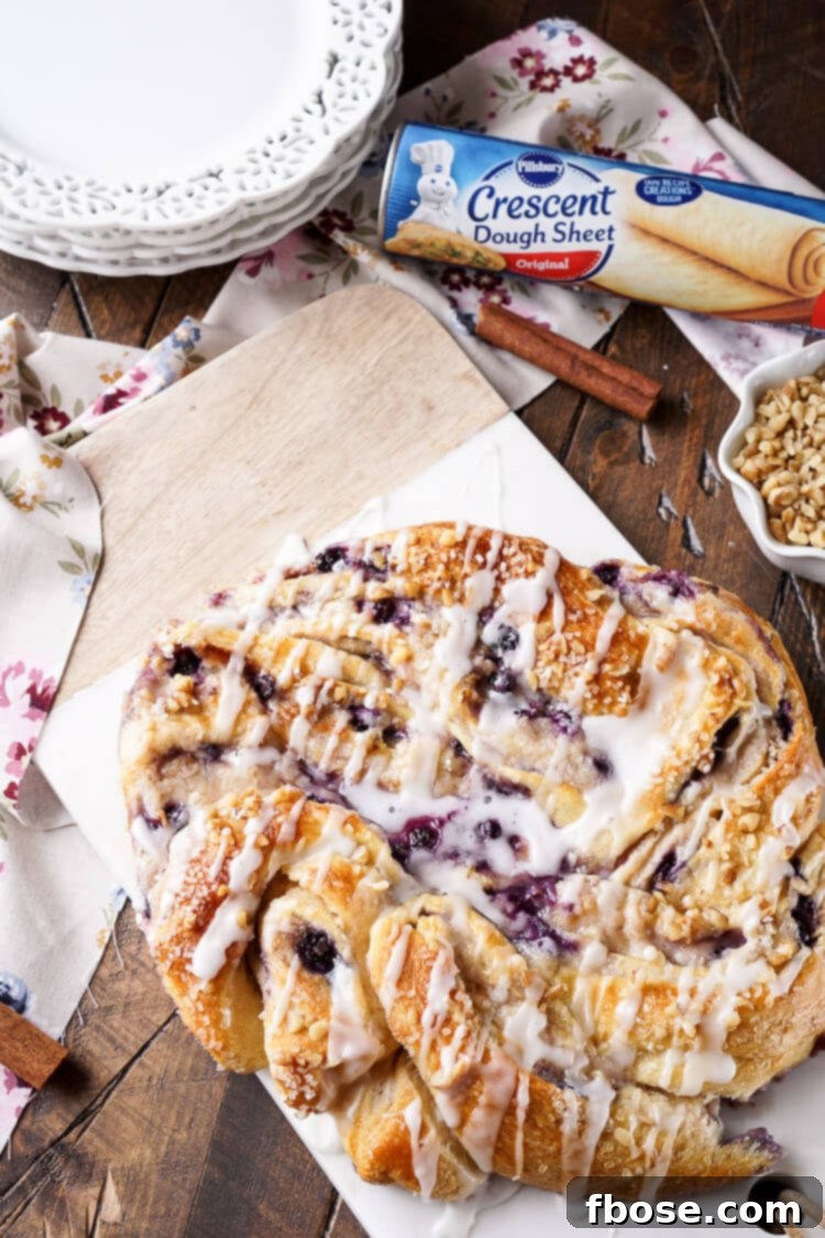 Spiced Blueberry Cream Cheese Twirl 7 This Blueberry Spice Cream Cheese Breakfast Ring is the perfect addition to a holiday brunch. A simple and sweet filling is wrapped up in crescent dough and topped with chopped pecans and icing for a delicious morning pastry the whole family can enjoy!