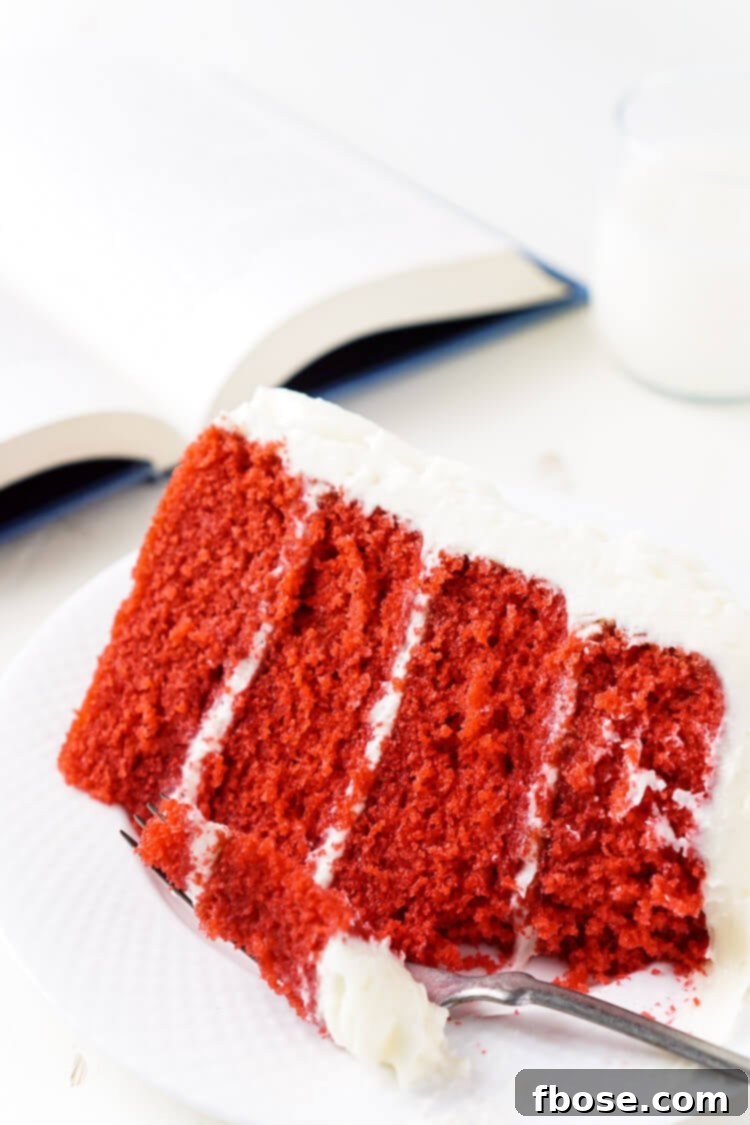 A stunning side view of the Red Velvet Cake, revealing its luscious layers and the delicate artistry of the white cream cheese frosting, a true showstopper.