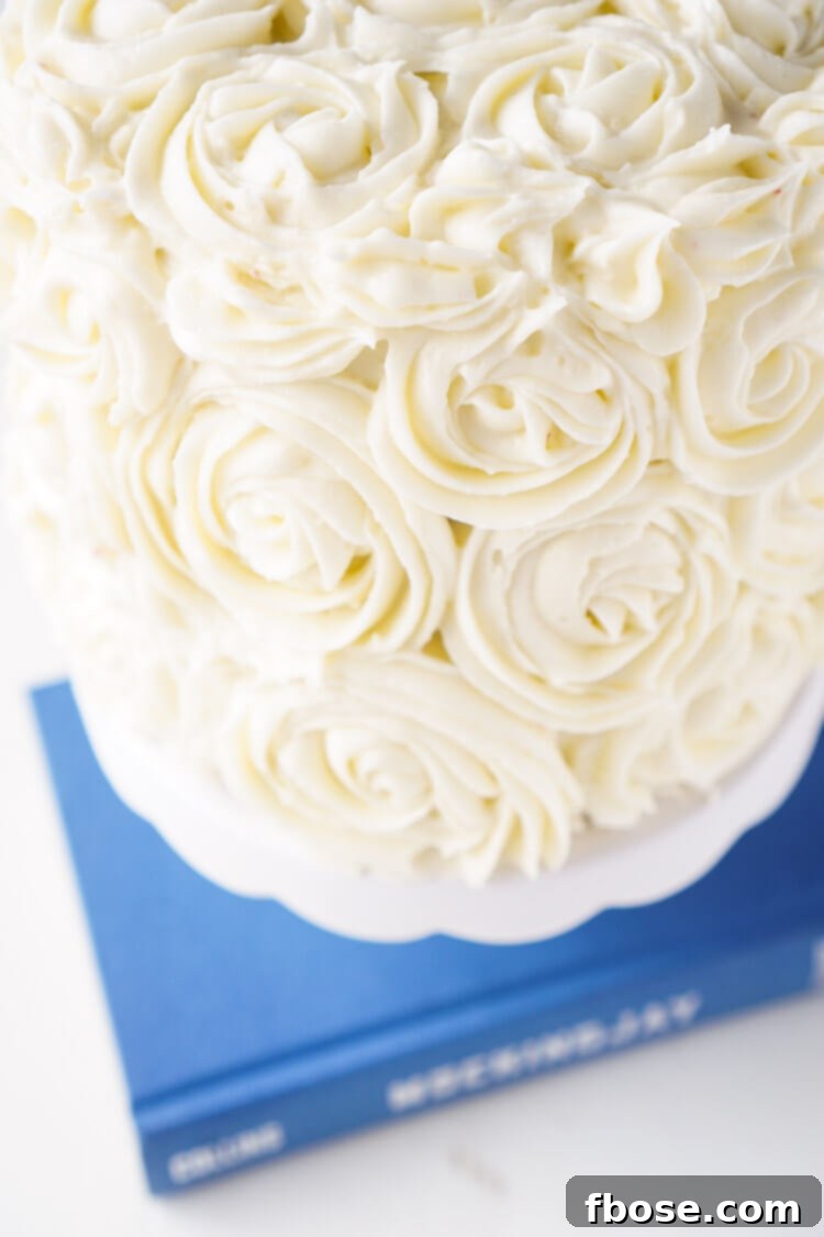 Close-up of a slice of Red Velvet Cake showcasing its vibrant red layers and rich cream cheese frosting, a delicious tribute to The Hunger Games universe.