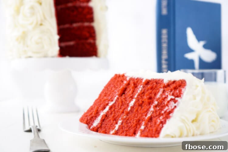 An overhead shot showcasing the magnificent Red Velvet Cake, frosted with elegant white cream cheese roses, a perfect centerpiece for a Hunger Games-themed gathering or Valentine's Day.