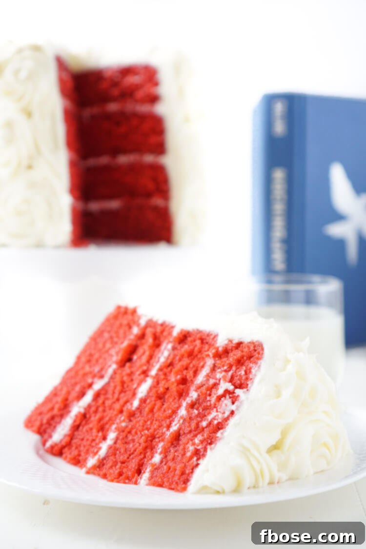 A close-up of the delicate white cream cheese roses adorning the top of the Red Velvet Cake, meticulously crafted to represent President Snow's signature symbol.