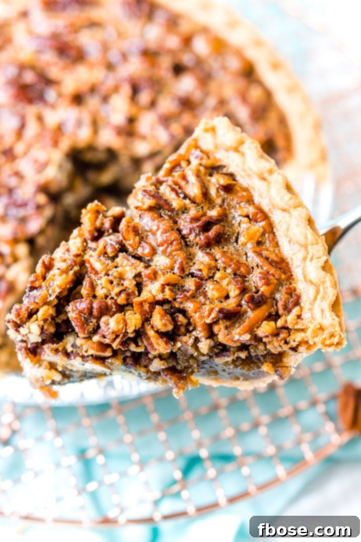 A whole pecan pie cooling on a wire rack.