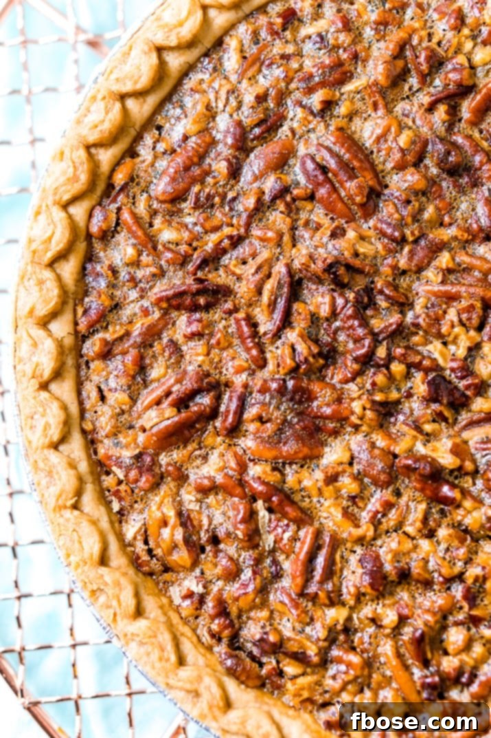 A beautiful pecan pie, ready to be sliced.
