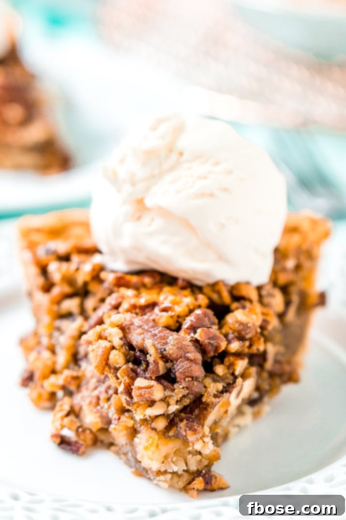 A slice of pecan pie on a plate with a fork.