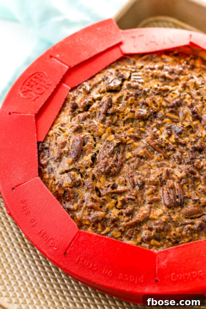 A full pecan pie, glistening and ready to be served.