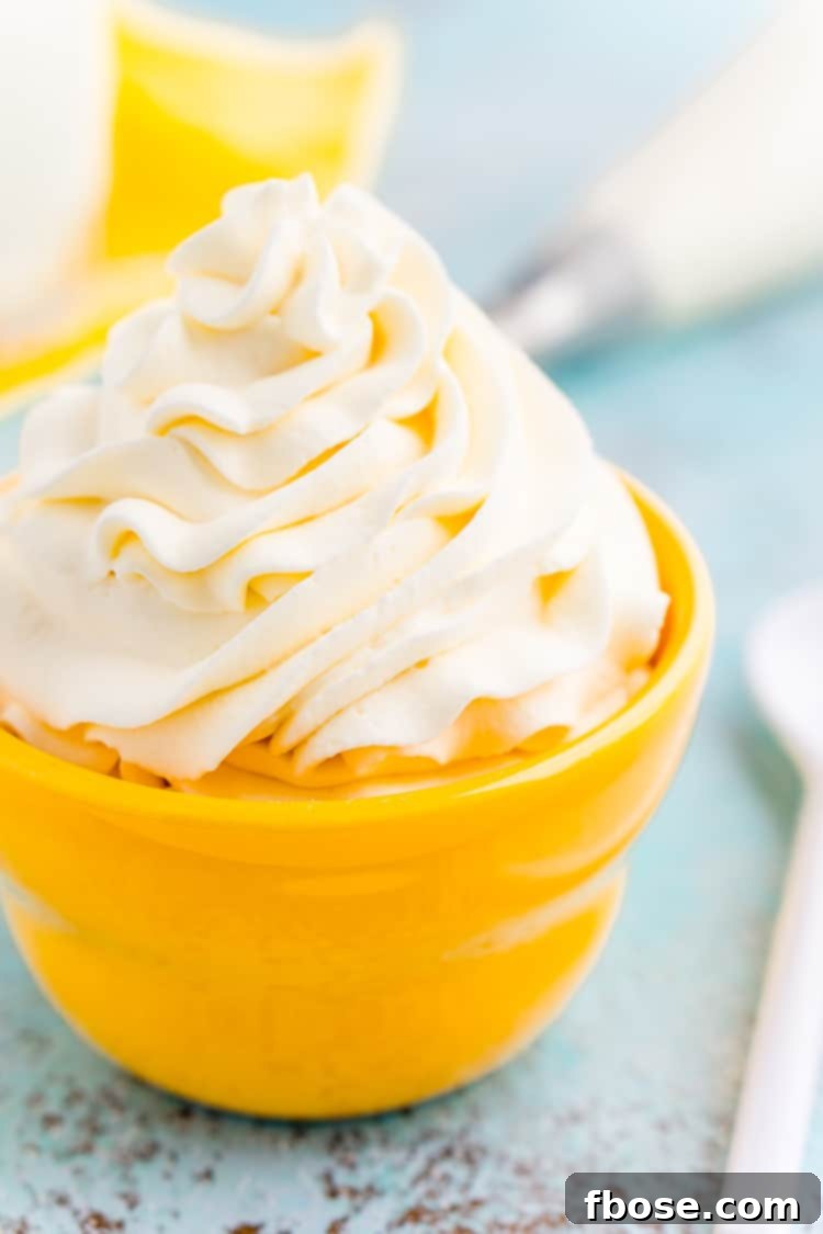 This Cream Cheese Whipped Cream is deliciously creamy and tangy topping for desserts, milkshakes, hot chocolate, and more! Made with just 4 ingredients and ready in 5 minutes!