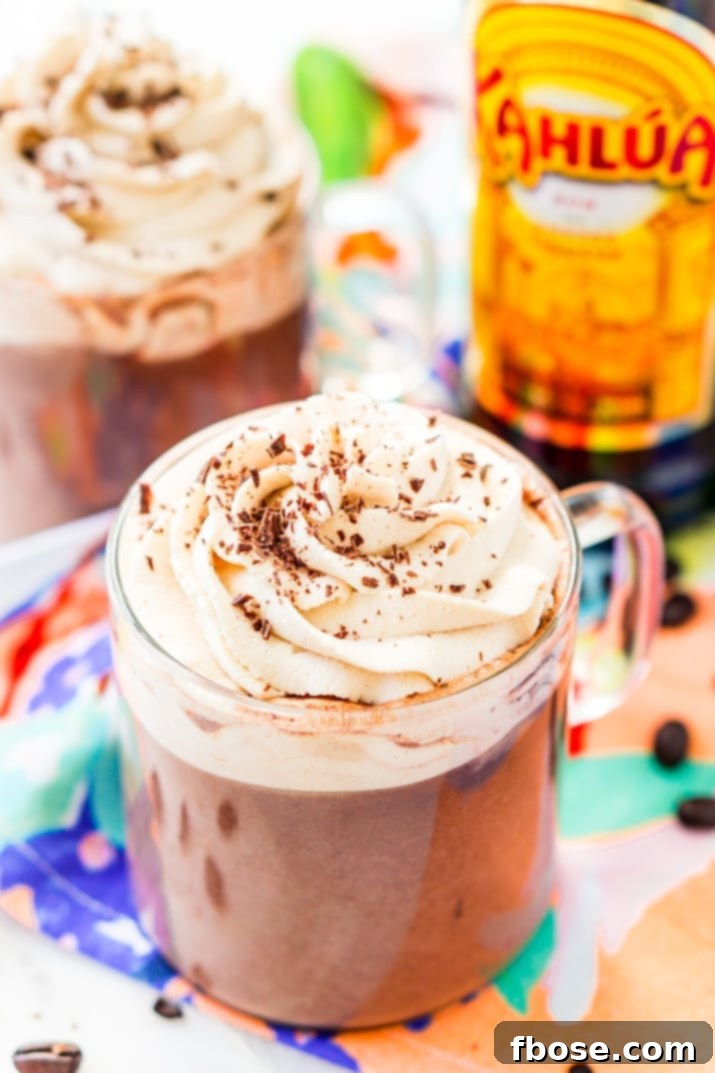 This Kahlua Hot Chocolate is so rich, creamy, and BOOZY! This hot chocolate recipe is laced with coffee liqueur and topped with a Kahlua Whipped Cream and chocolate shavings.