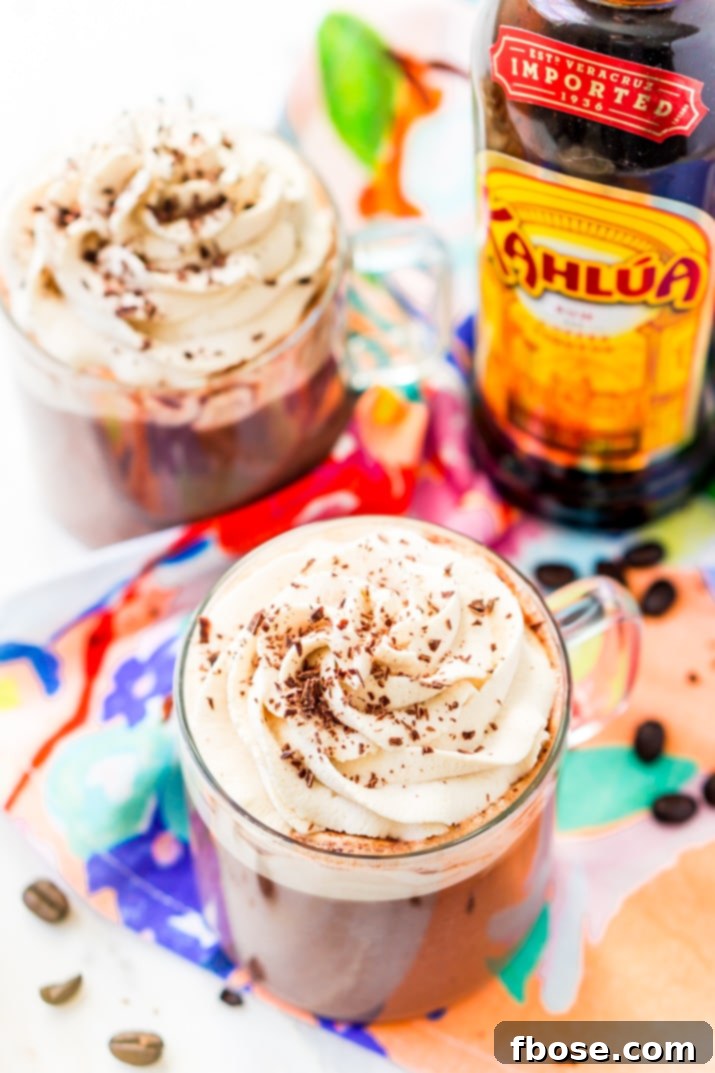 Boozy Hot Chocolate made with kahlua topped with whipped cream and chocolate shavings.