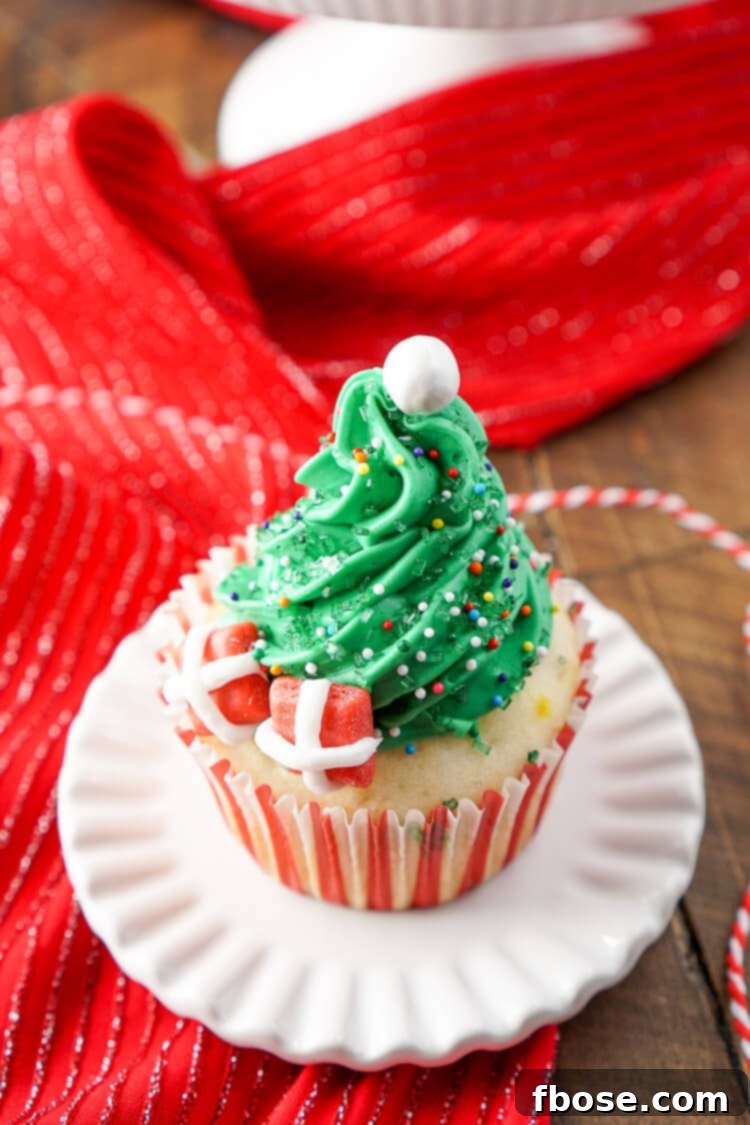 A festive spread of various Christmas Tree Cupcakes, showcasing different decorations and angles