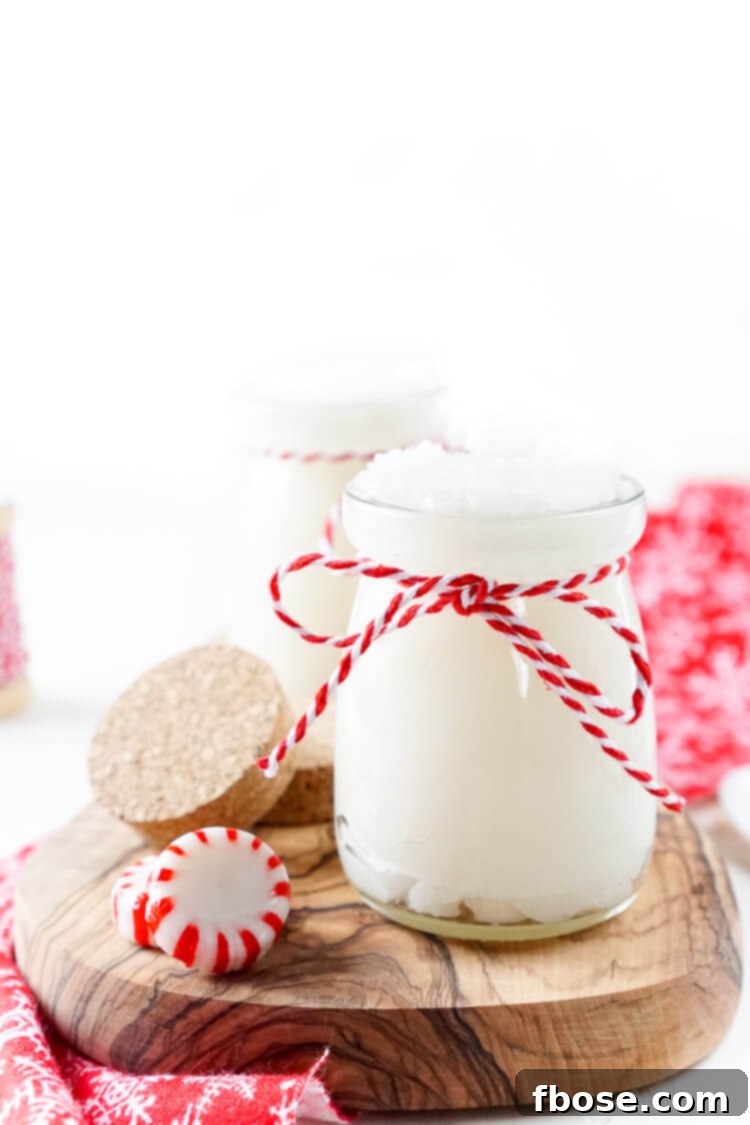 Minty Fresh Sugar Polish 5 A festive holiday gift basket featuring the peppermint sugar scrub jar, accompanied by a cozy hand towel and other spa essentials.