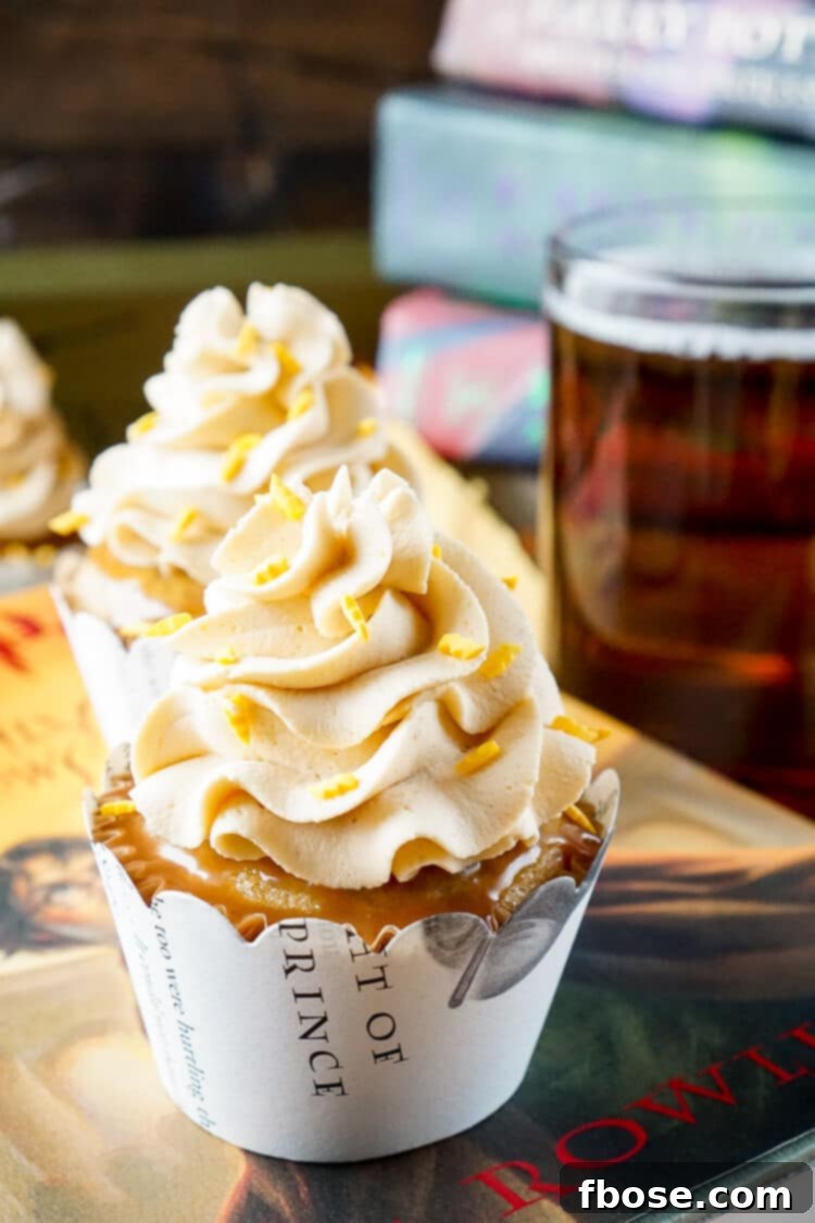 Delicious Harry Potter Butterbeer Cupcakes on a rustic wooden surface, topped with whipped frosting and lightning bolt sprinkles, evoking magical flavors.