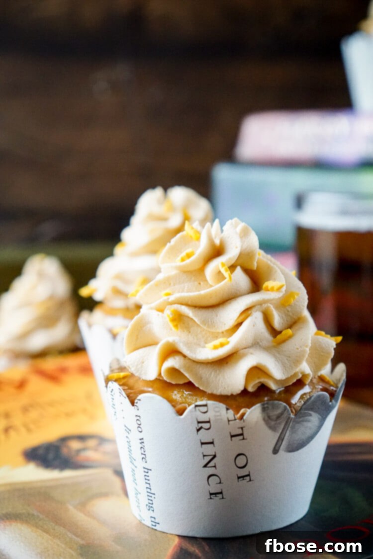 A close-up of a single Harry Potter Butterbeer Cupcake, highlighting the detailed frosting and the magical ambiance.