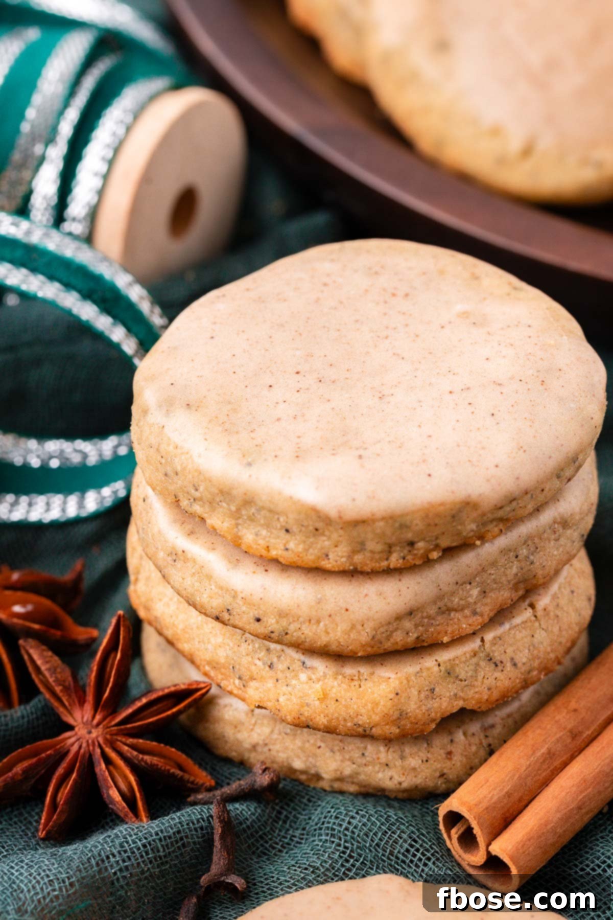 A stack of chai cookies on a green napkin.