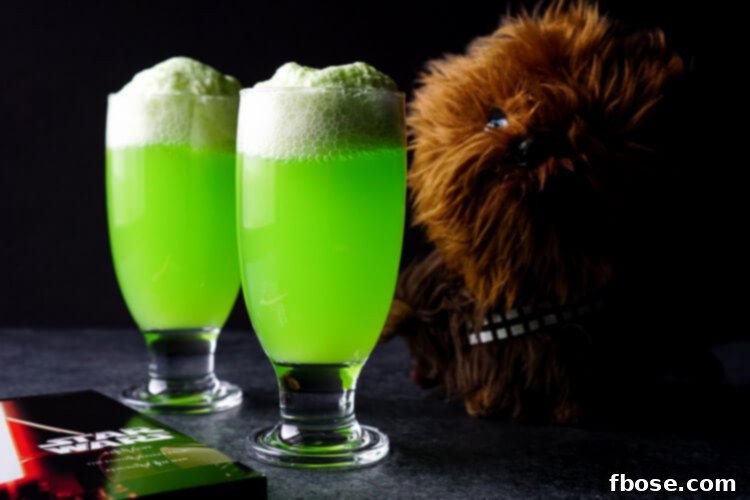 Close-up of a Yoda Soda Float in a clear glass, with the green liquid and vanilla ice cream creating an appetizing visual.