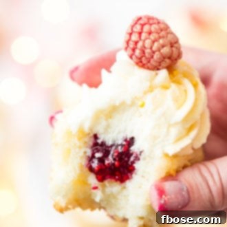 These White Chocolate Raspberry Champagne Cupcakes are perfect for New Year's Eve, Bridal and Baby Showers, and Valentine's Day! Light and fluffy white chocolate cake filled with raspberry filling and topped with a luscious champagne buttercream!
