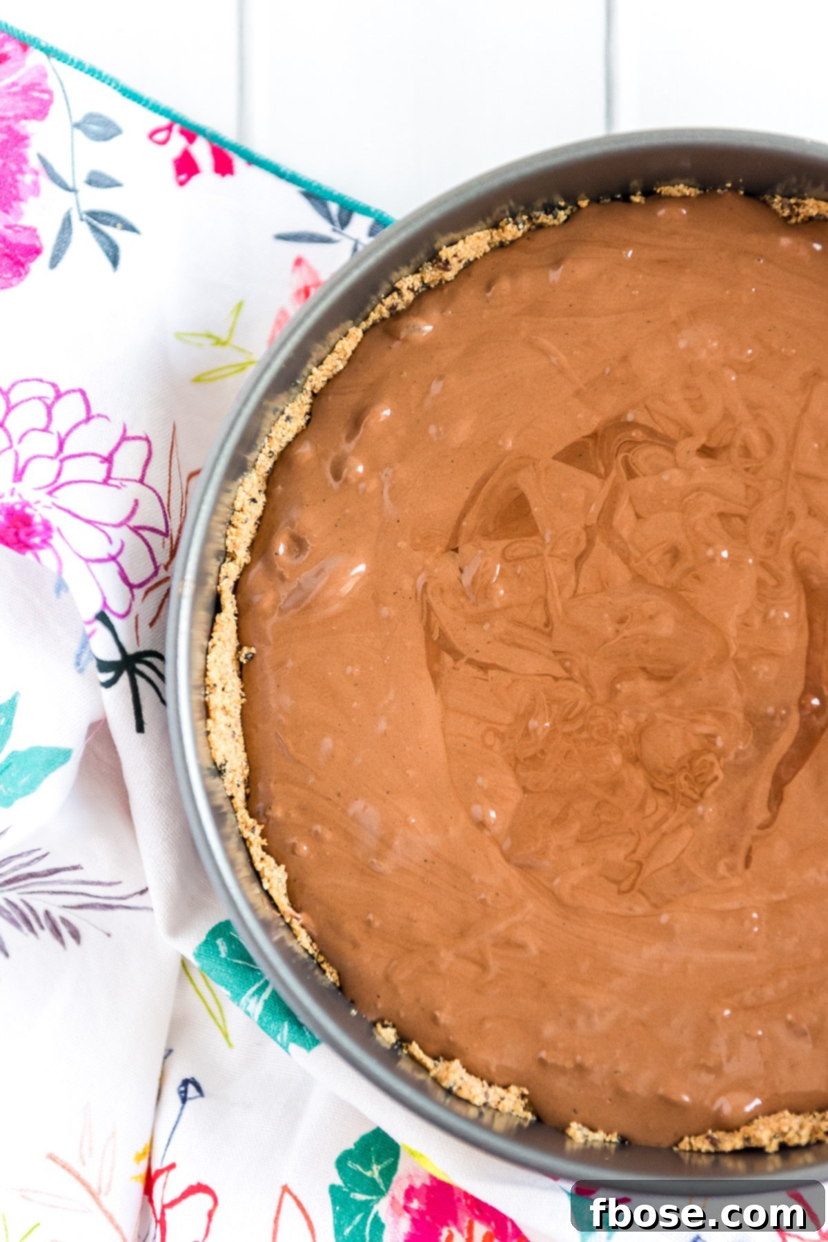 Fudgy Brownie Pie 8 Brownie batter smoothly poured into a prepared graham cracker pie crust within a springform pan, ready for baking.
