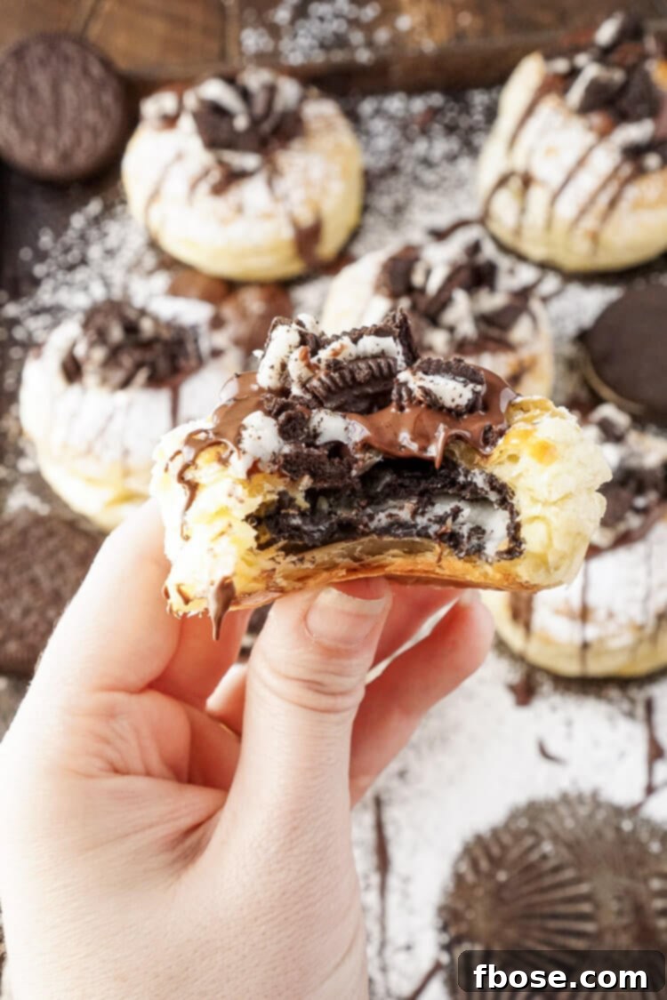 A close-up shot of a Croissookie on a white plate, highlighting its texture and topping.
