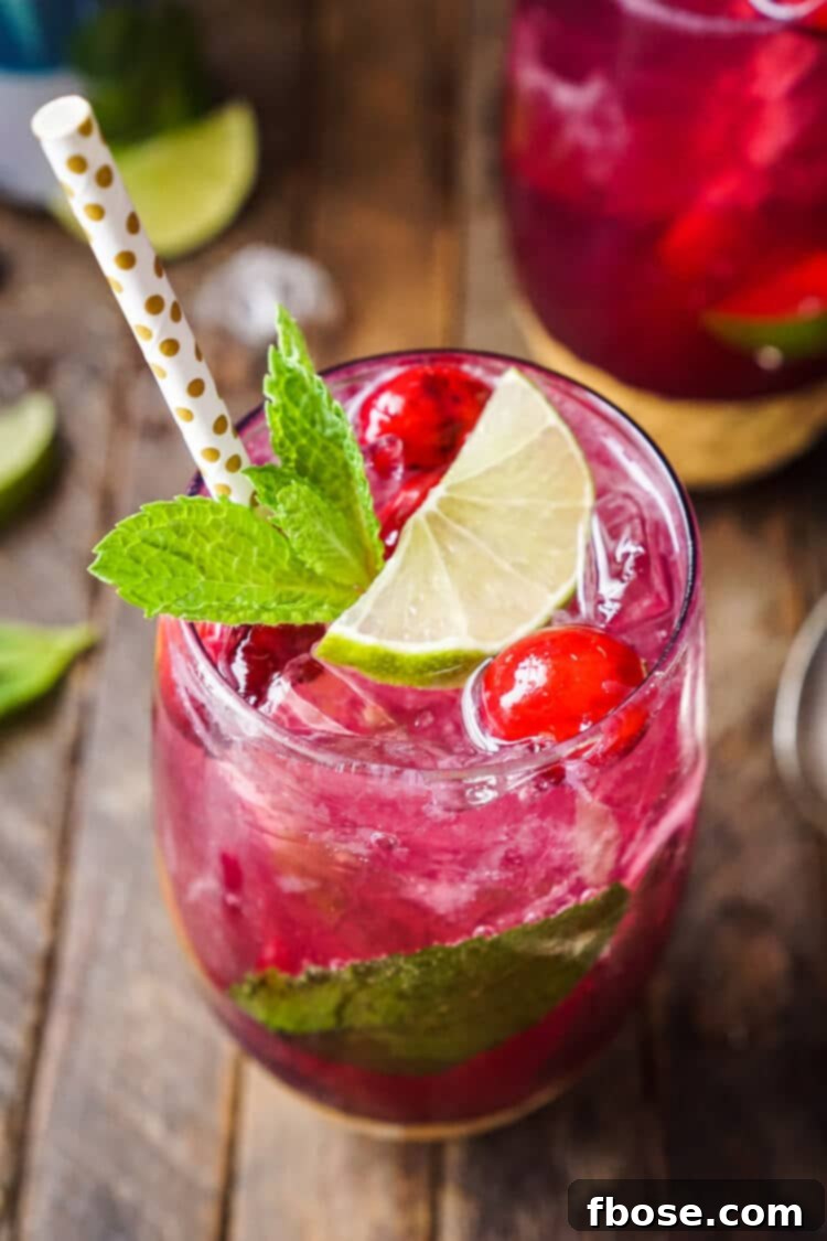 This Cranberry Mojito Punch is so refreshing and flavorful! It's a festive sparkling cocktail that's sure to have everyone dancing the night away at your holiday party! The red and green make it the perfect Christmas cocktail recipe!