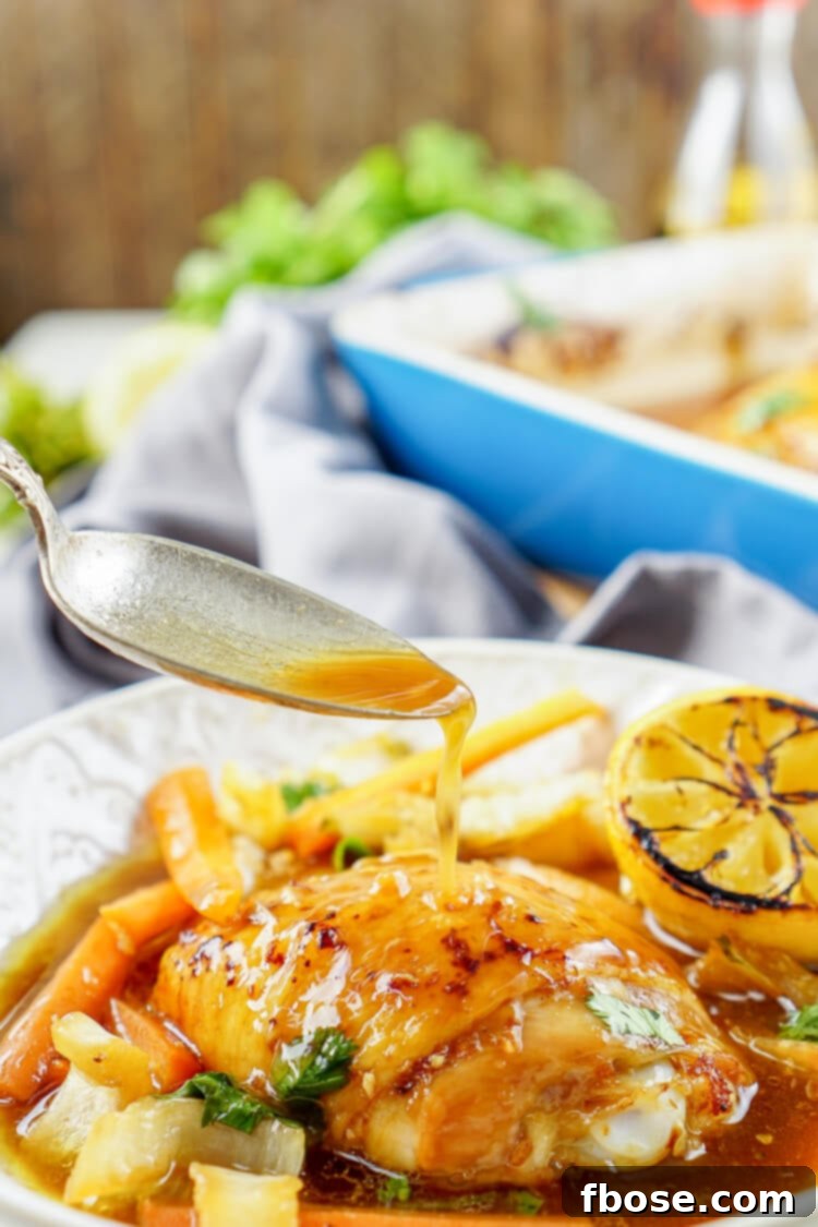 A delectable platter of slow-roasted Lemon Ginger Soy Chicken Thighs, glistening with glaze, served alongside vibrant bok choy and tender carrots.