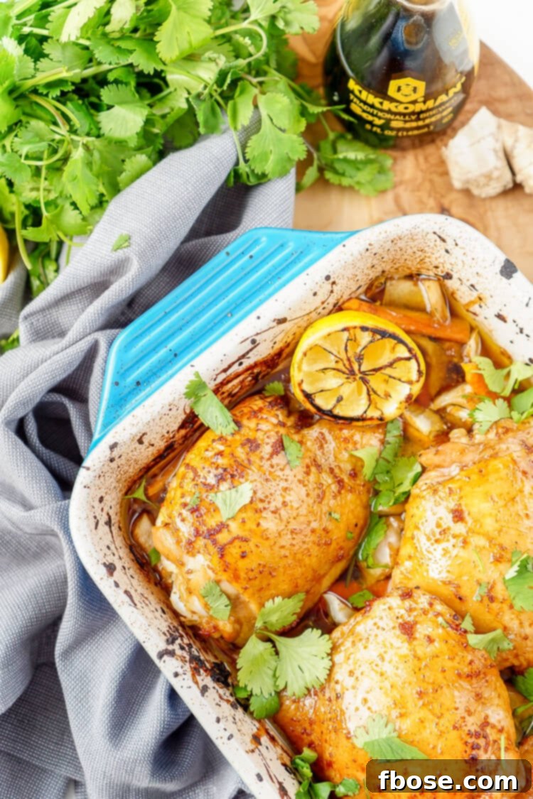 Lemon Ginger Soy Chicken Thighs plated elegantly with roasted bok choy and carrots, garnished with fresh cilantro for a final flourish.