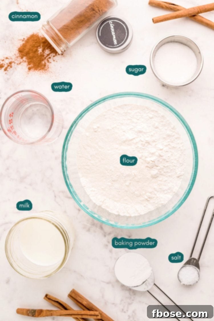 Effortless Bannock Bread 4 Overhead photo of ingredients prepared to make bannock bread, including flour, milk, water, and cinnamon sugar.