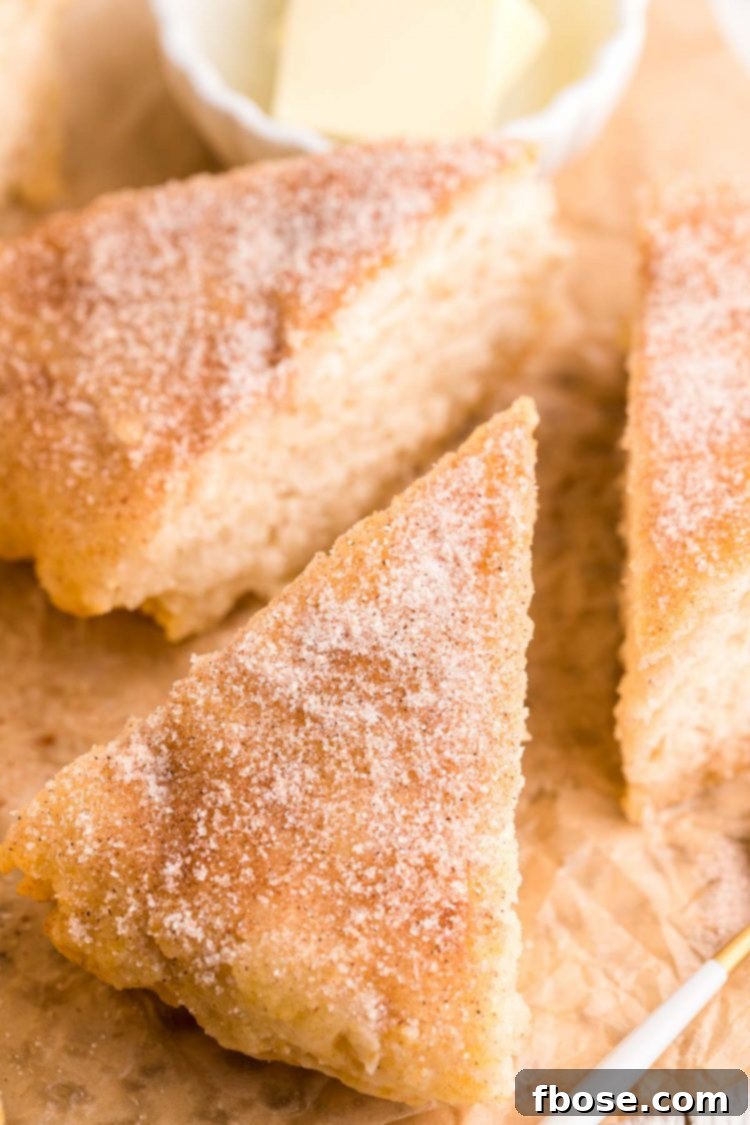 Effortless Bannock Bread 6 Close up photo of slices of bannock bread topped with cinnamon sugar on parchment paper, ready to be served.