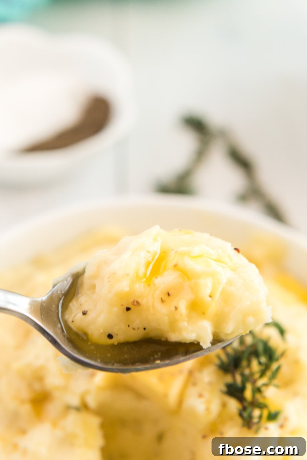 Close up photo of a spoonful of Homemade Mashed Potatoes.