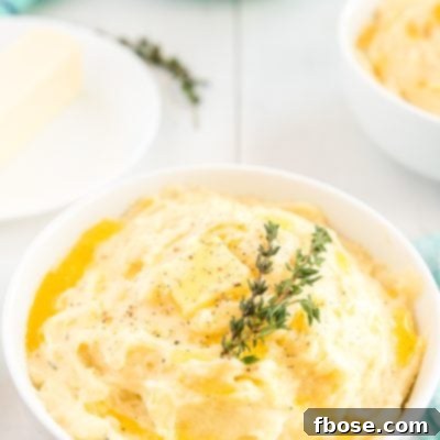 These are The Best Creamy Mashed Potatoes you'll ever make and super easy too! They're loaded with butter, milk, and cream and flavored with garlic and thyme and a touch of salt and pepper!