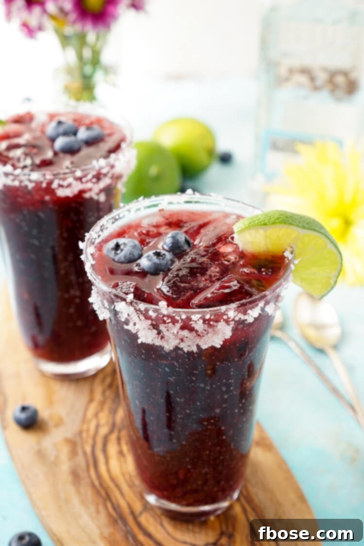 Indulge in this Fresh Blueberry Margarita, a delightful fusion of ripe blueberries and Altos Tequila, offering a distinctive New England spin on the classic cocktail.