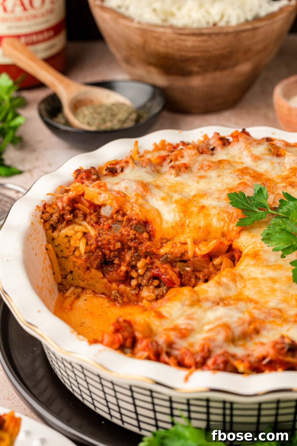 Spaghetti pie missing a piece from the pan.