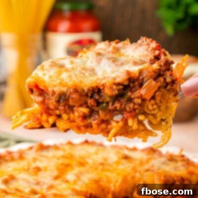 Spaghetti Pie on a spatula being lifted from a pie dish.