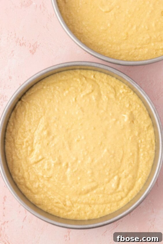 Cake batter in two round pans.
