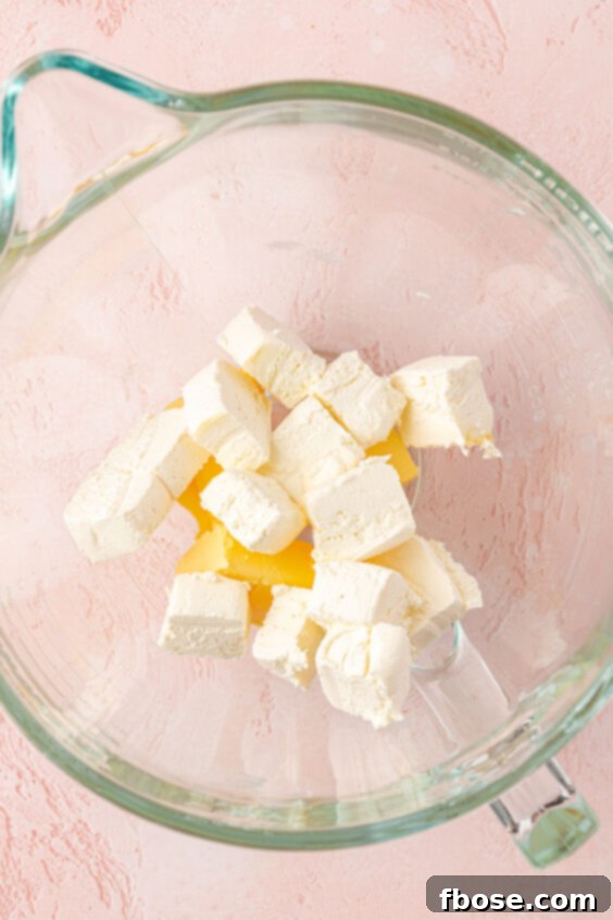Butter and cream cheese in a mixing bowl.