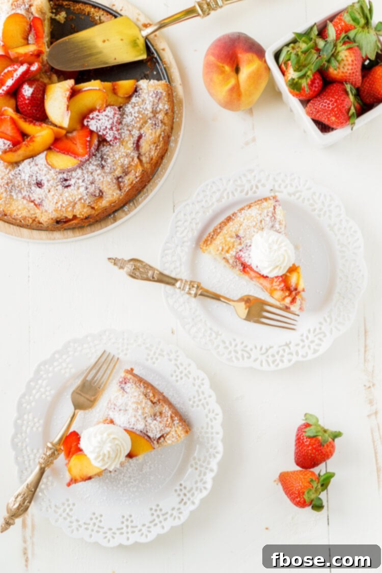 Strawberry Peach Coffee Cake 7 An overhead shot of the full Strawberry and Peach Coffee Cake, garnished with fresh fruit and whipped cream.