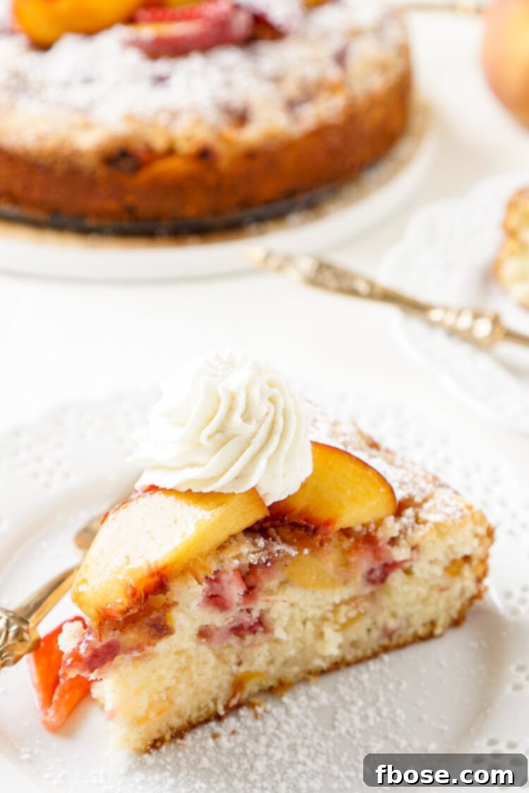 Strawberry Peach Coffee Cake 8 A close-up, tempting photo of a slice of Strawberry and Peach Coffee Cake, showing the fruit and crumb.