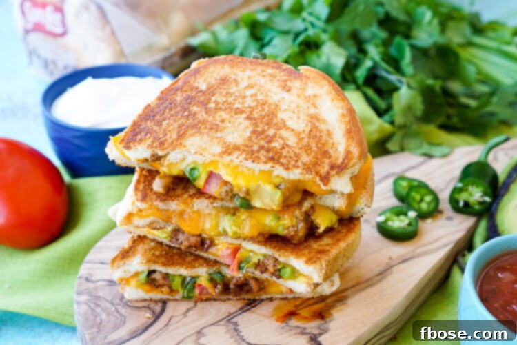 Several Taco Grilled Cheese Sandwiches stacked, showcasing the thick, golden bread and melted cheese.