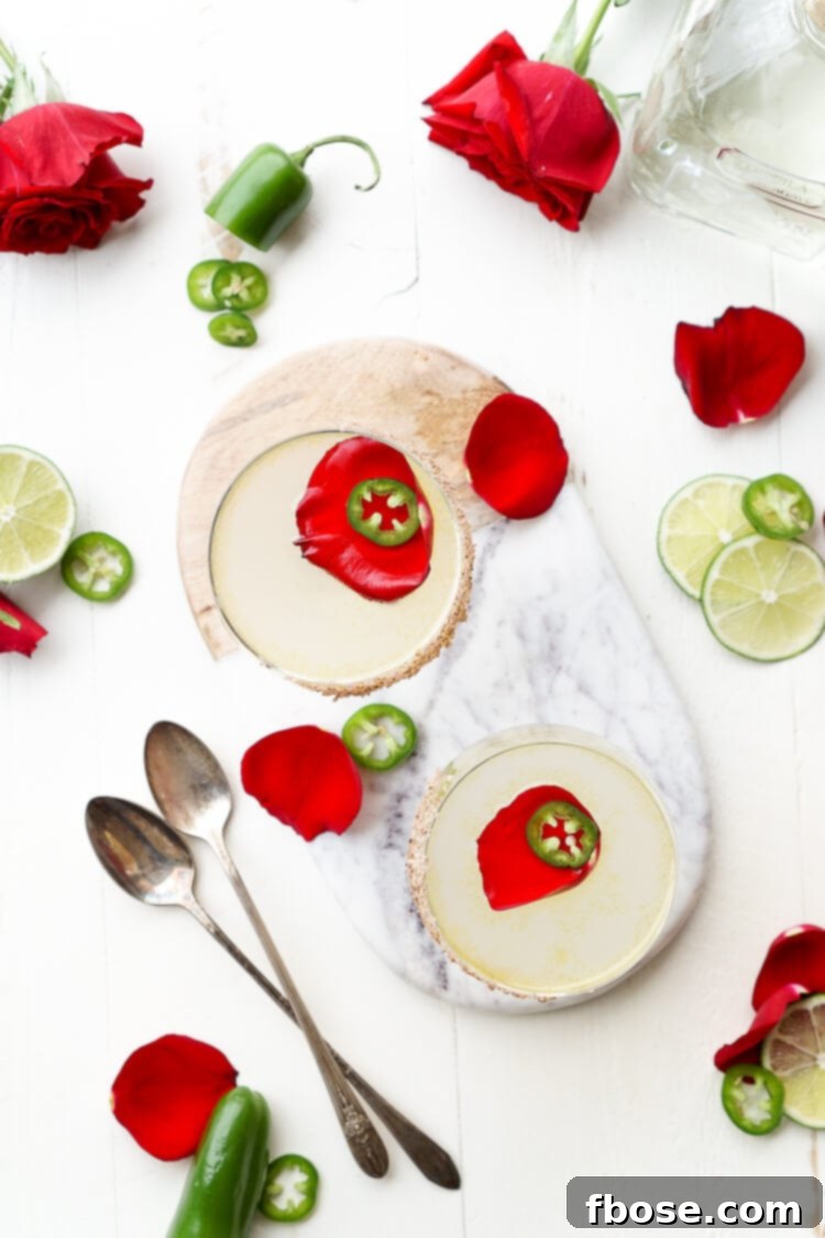 A sophisticated Spicy Jalapeño Margarita glass, showcasing the balance of heat and fresh floral notes.