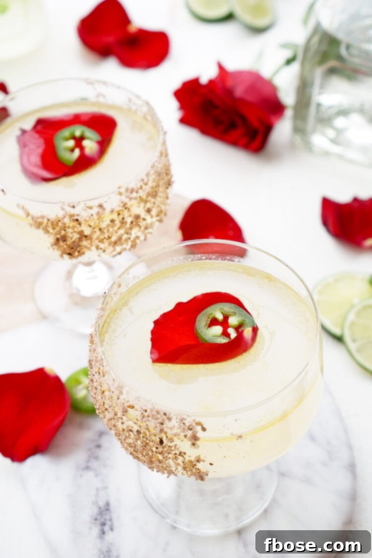 A beautifully composed image of the Patrón Rosa Picante Margarita, highlighting its vibrant color and elegant garnish, alongside the premium ingredients.