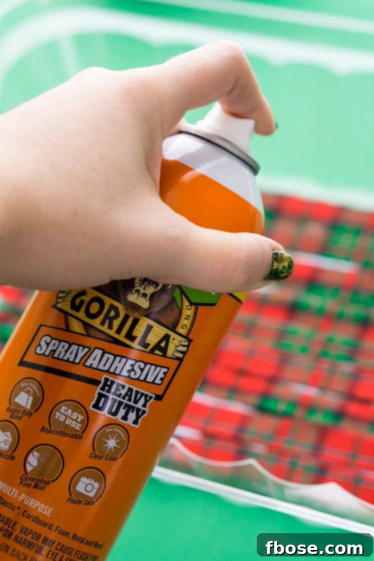 Spraying fabric strips with Gorilla Spray Adhesive for DIY Holiday Rag Balls.