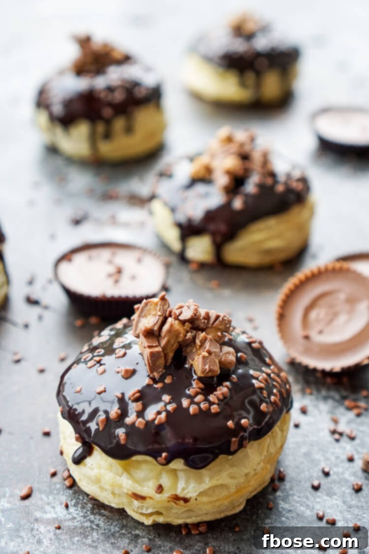 Reese's Stuffed Puff Pastry Donuts with chocolate drizzle and sprinkles