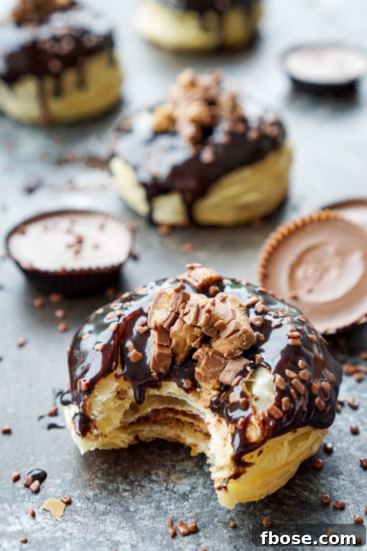 Reese's Stuffed Puff Pastry Donut dipped in chocolate sauce with sprinkles