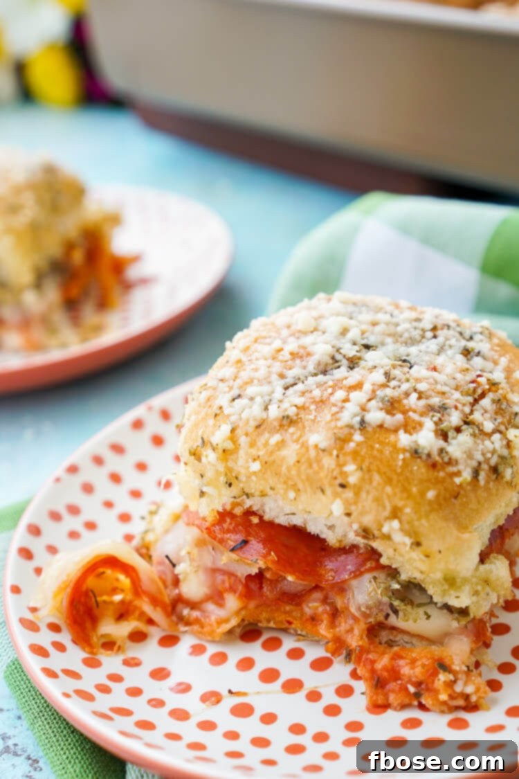 Overhead view of Easy Pizza Sliders arranged on a baking sheet, showcasing the ingredients before baking.