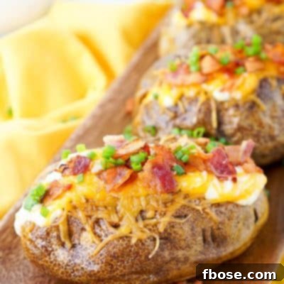 Best Ever Baked Potatoes, perfectly seasoned and loaded up with a creamy dressing, cheddar cheese, bacon, and chives!