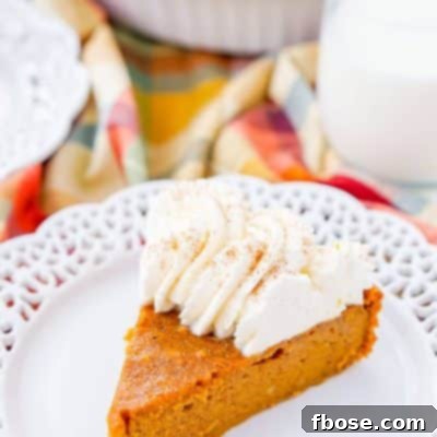 Delicious and Easy Impossible Pumpkin Pie, a crustless fall dessert topped with homemade whipped cream.