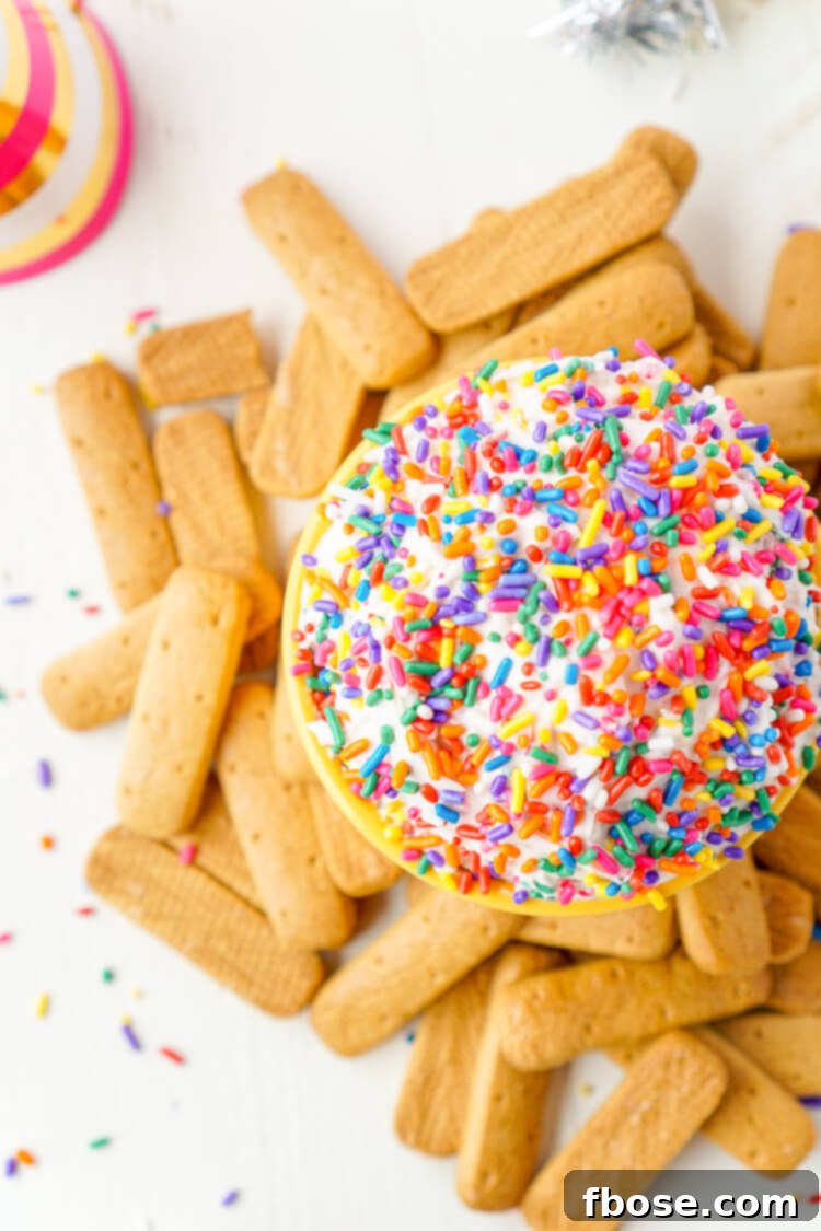 Close-up of Funfetti Birthday Cake Dip with a spoon scooping, showing its creamy texture and sprinkles.