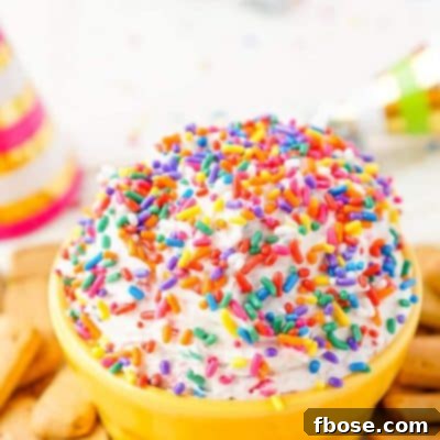 A top-down shot of the vibrant Funfetti Birthday Cake Dip, showcasing its sprinkles and creamy texture.