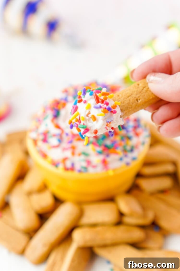 A bowl of Funfetti Birthday Cake Dip from a slightly elevated angle, with a focus on its creamy texture and festive sprinkles.