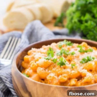 Close-up of Marinara Mac and Cheese in a bowl, showcasing the blend of cheese and tomato sauce.